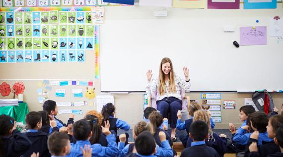 A teacher in the classroom teaching.