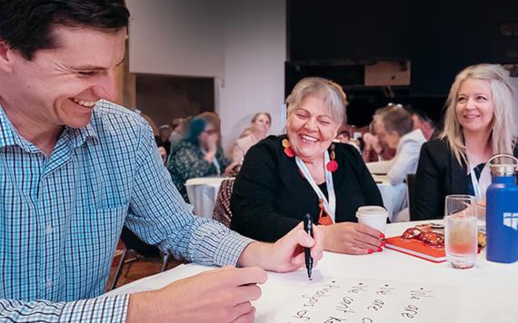 Teachers working at tables at Conference 